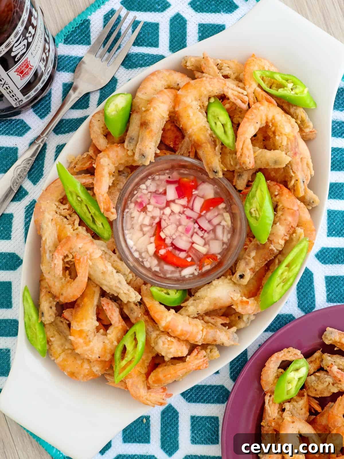 Crispy Fried Drunken Shrimp on a clear glass platter with spicy vinegar on the side