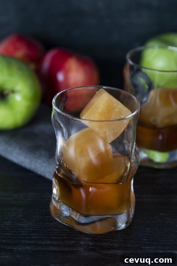 Close-up of bourbon poured over apple cider ice