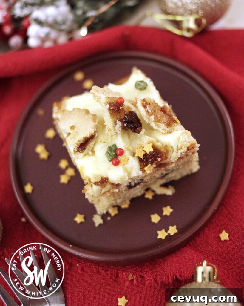 Mincemeat Cake: Festive Mince Pie Layer Cake Recipe 9 slice of Christmas mincemeat traybake cake decorated with broken mince pies and golden star sprinkles