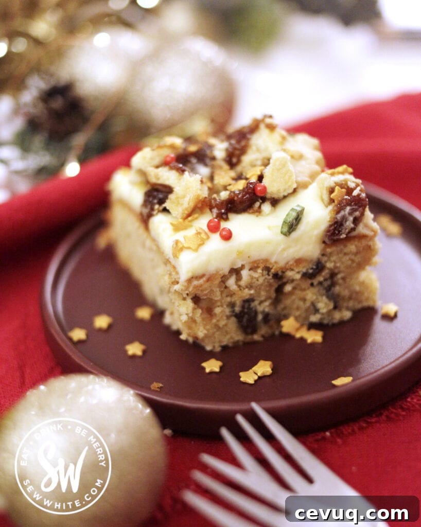 Mincemeat Cake: Festive Mince Pie Layer Cake Recipe 3 slice of mincemeat traybake with cream cheese buttercream and sprinkles. Purple plate on a red cloth with two forks and foliage in the background