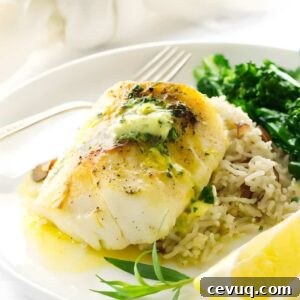 Broiled cod with herb butter on rice pilaf, greens, and lemon.