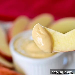 caramel cream cheese apple dip on an apple slice