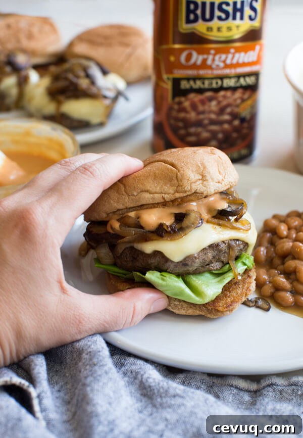 Mushroom Swiss Burger on a bun with melted Swiss cheese and mushrooms