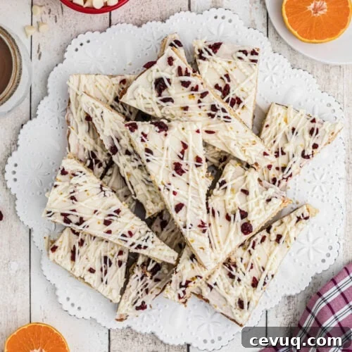 Overhead shot of cranberry bliss bars on white plate.