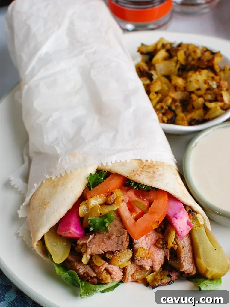 Authentic Beef Shawarma Recipe: Tender Spiced Meat & Garlic Sauce 2 Beef Shawarma in pita wrap
