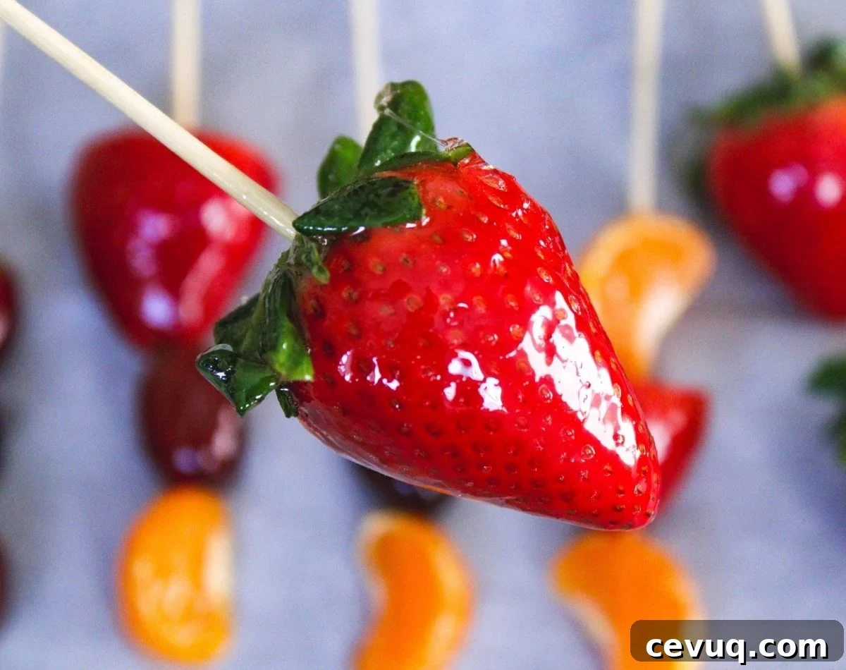 Tanghulu: Traditional Chinese Candied Fruit Guide & Recipe 7 candied strawberry being held above other candied fruit
