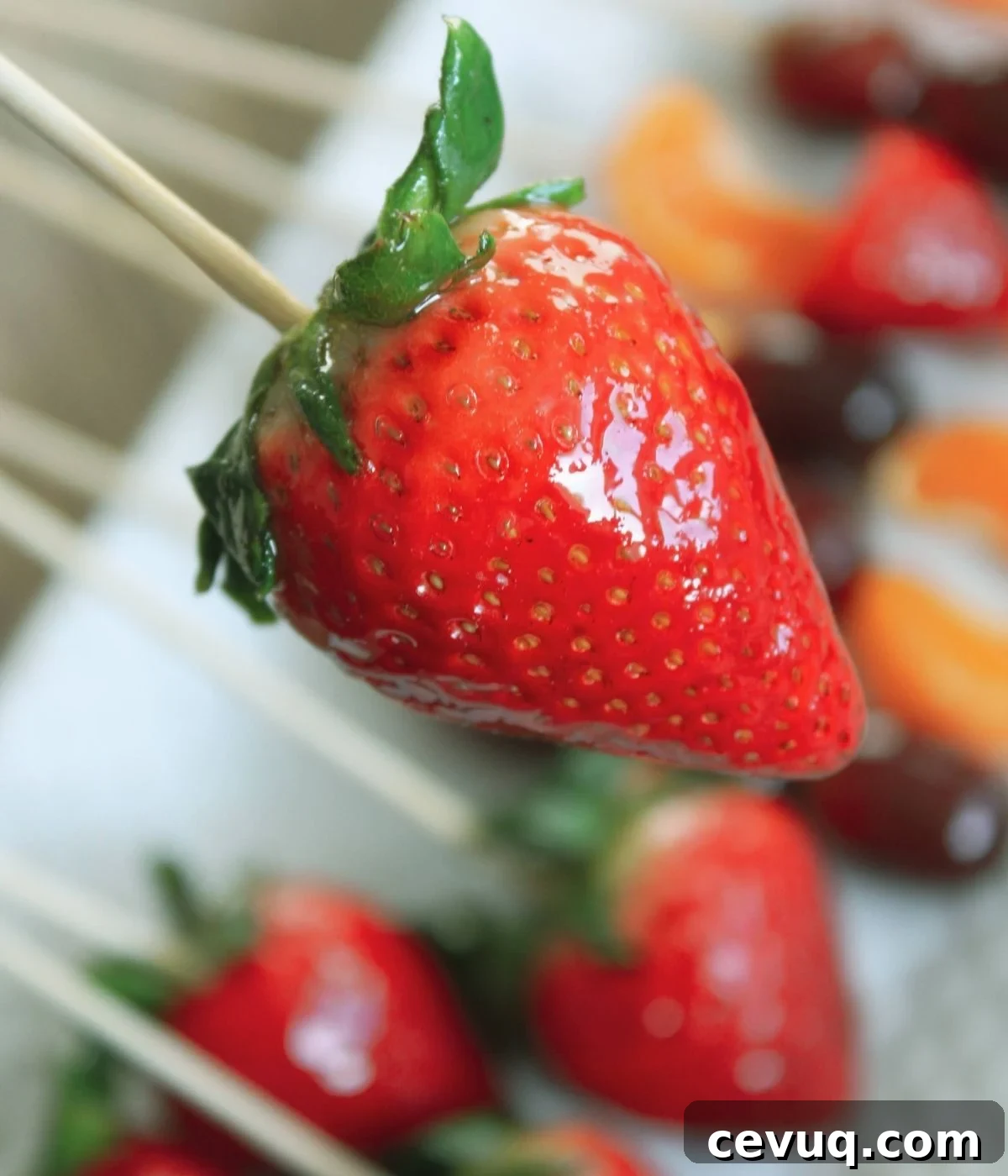 Tanghulu: Traditional Chinese Candied Fruit Guide & Recipe 8 candied strawberry on a bamboo skewer.