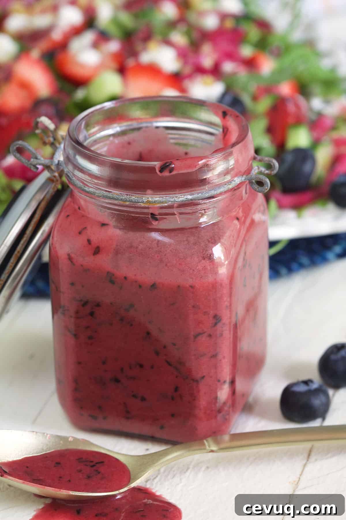 An open jar is filled with blueberry vinaigrette.