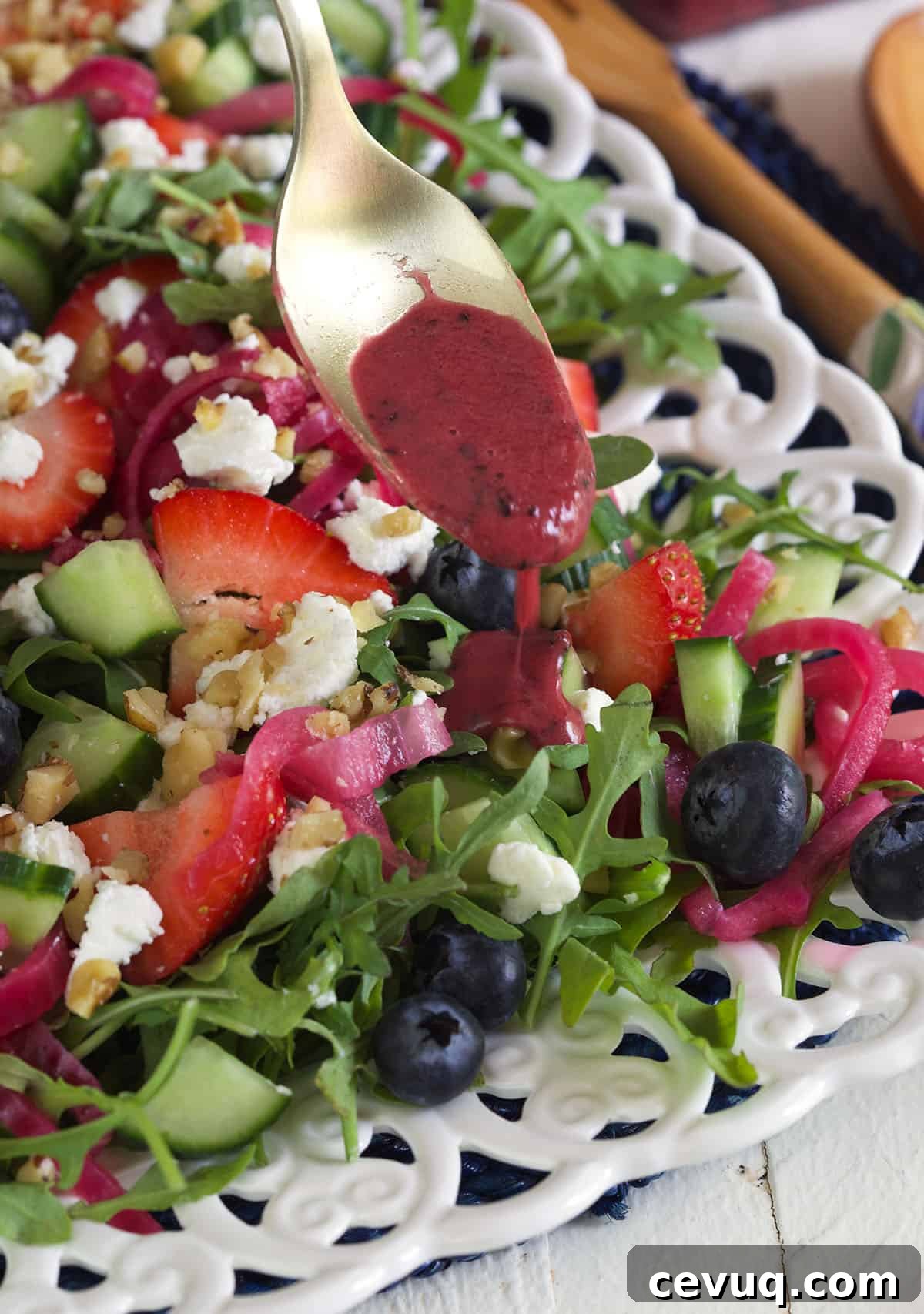 Vinaigrette is being drizzled on top of a salad.