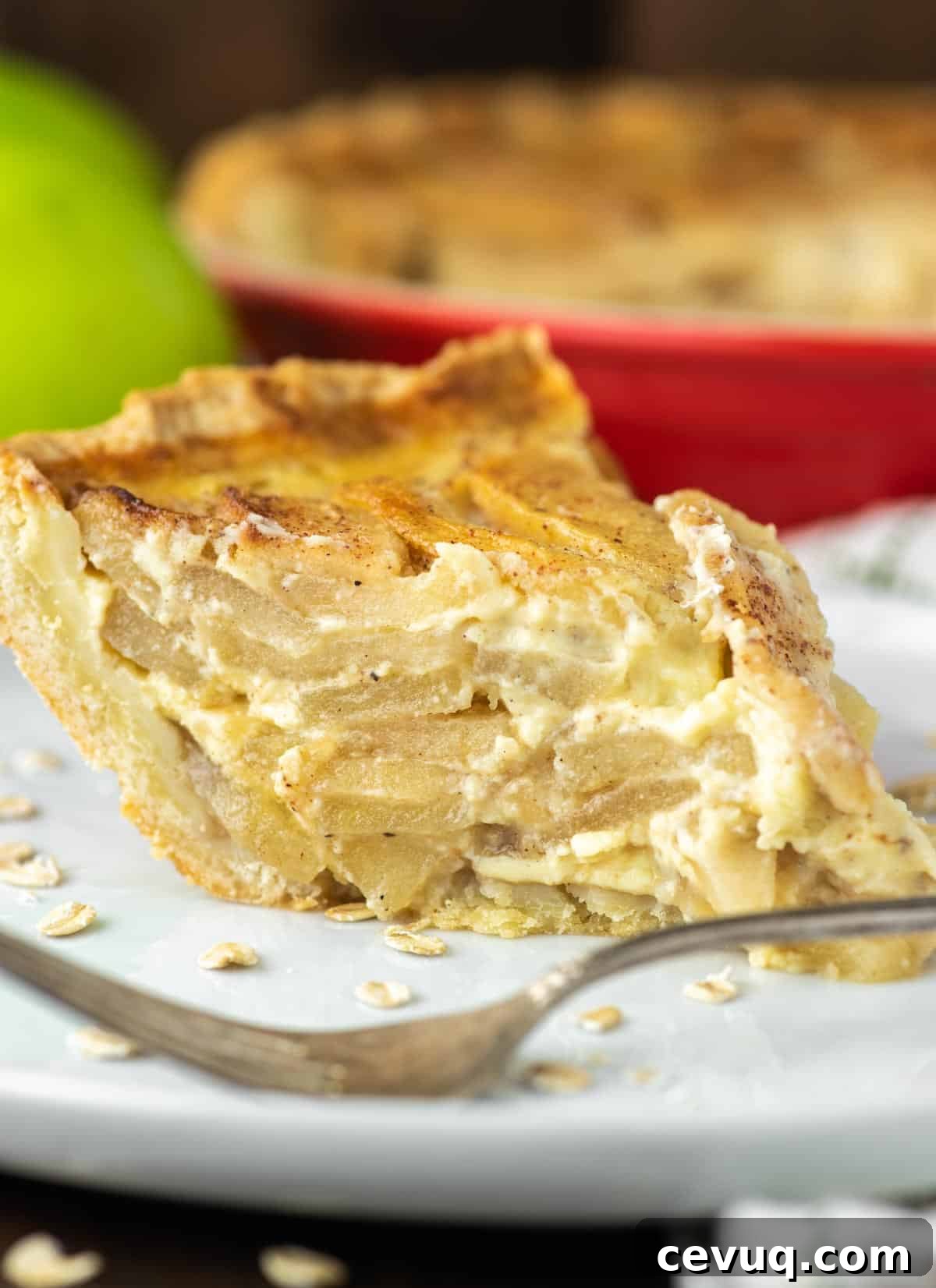 slice of apple custard pie on white plate with fork