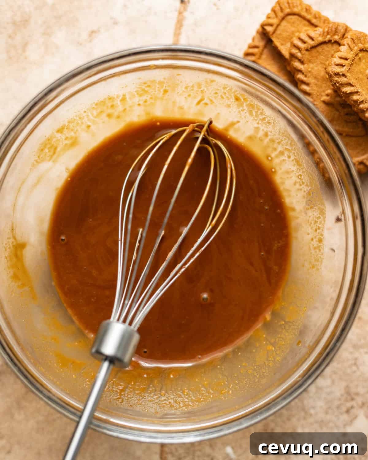 cookie butter, sugar, hot espresso, vanilla extract, and dash of cinnamon mixed together in a bowl.
