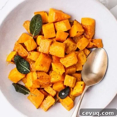 A bowl of air fryer butternut squash garnished with crispy sage.
