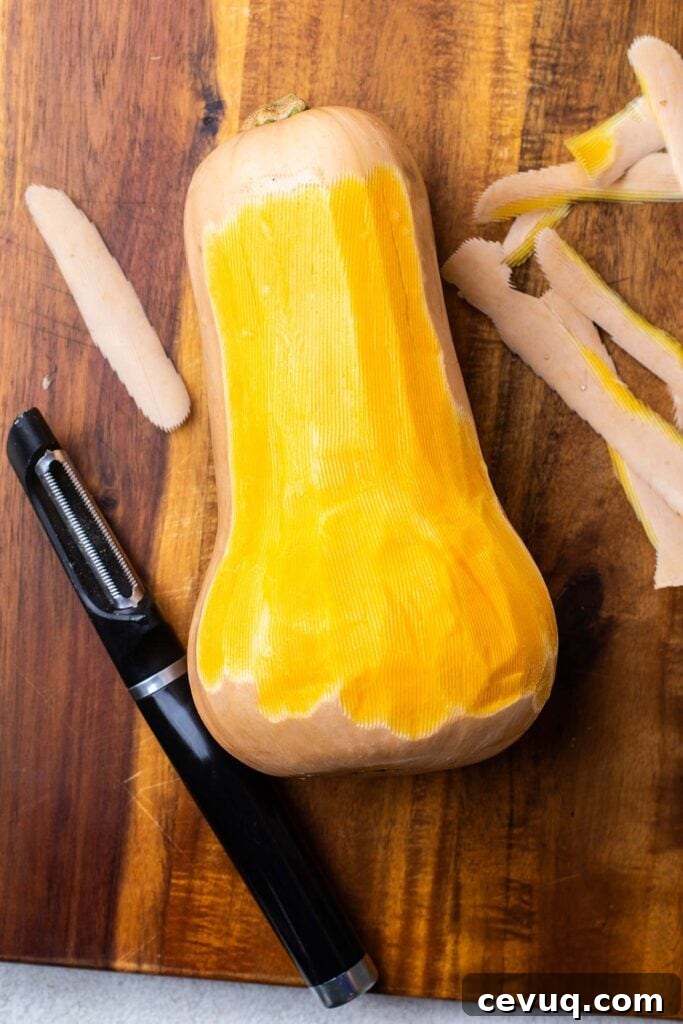 A butternut squash being peeled.