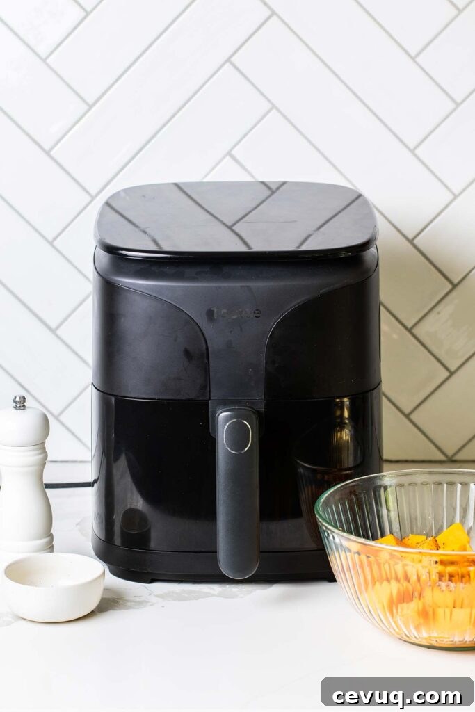 An air fryer sitting on the counter being preheated.