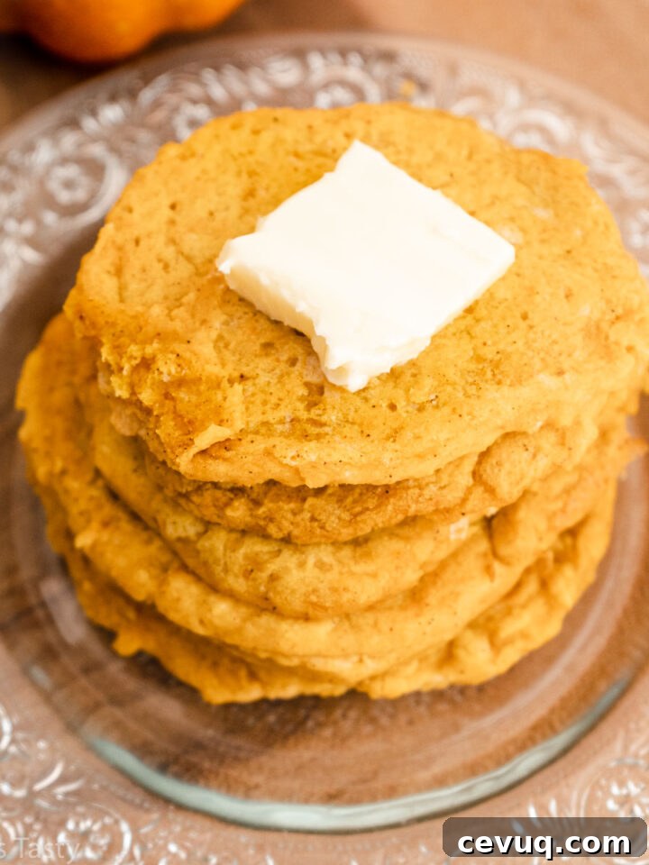 Close-up of a stack of gluten free pancakes with butter on top.