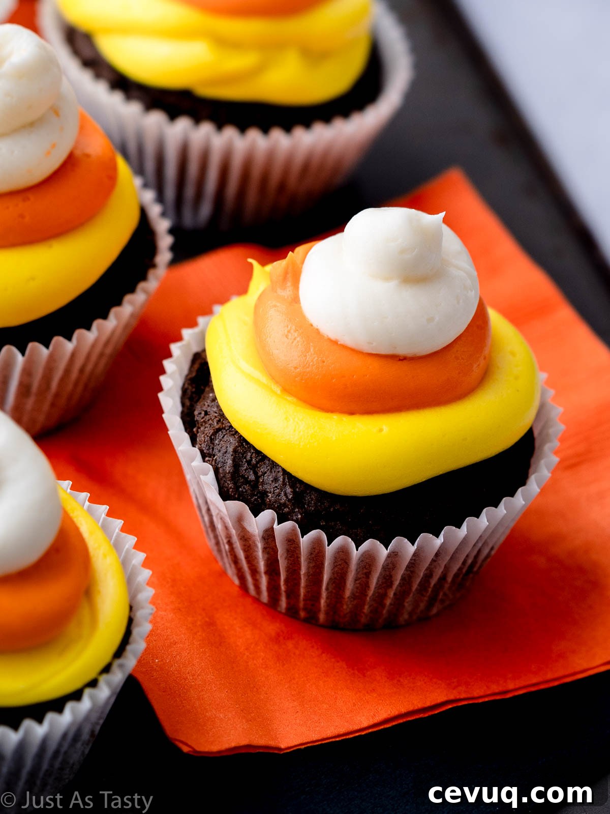 Candy Corn Cupcakes for Halloween: Festive Cupcake Recipe 9 Close-up of a chocolate cupcake topped with candy corn frosting.