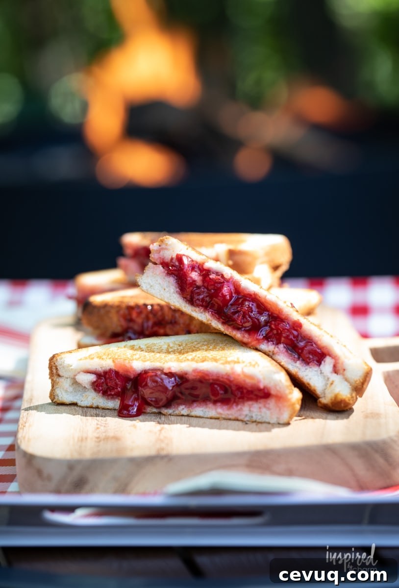cherry mountain pies stacked on cutting board.