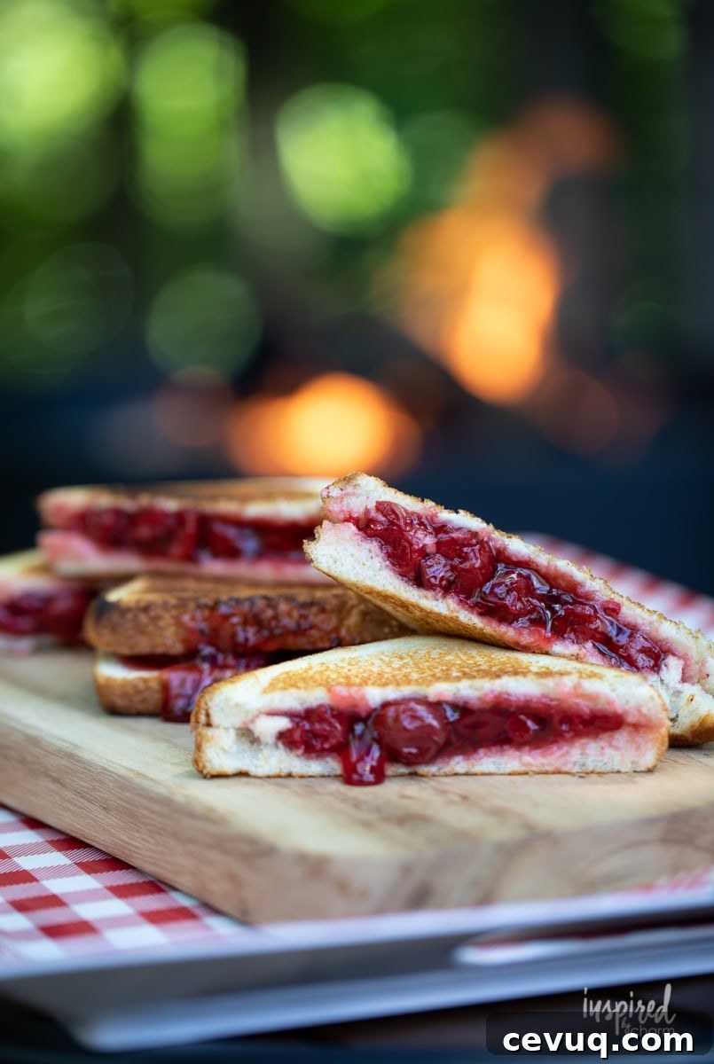 cherry mountain pies stacked on cutting board.
