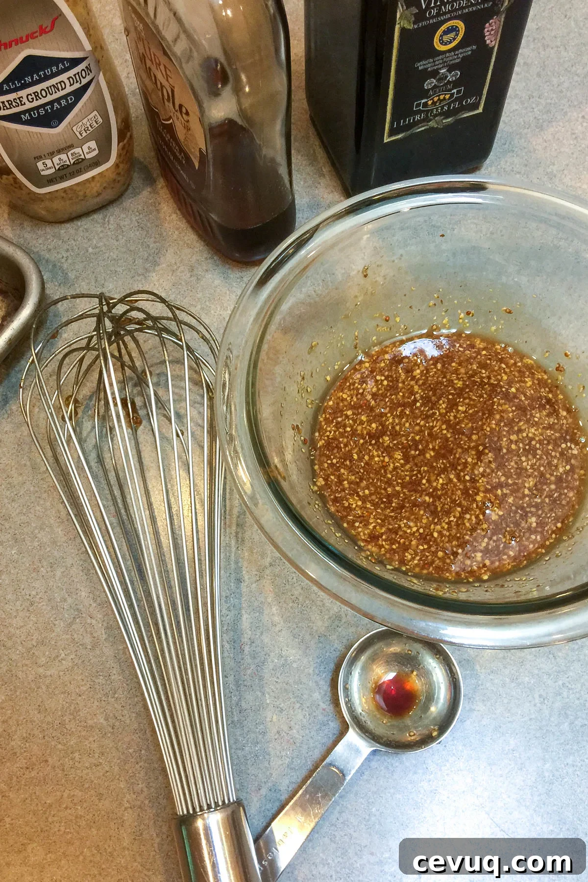 Whisking glaze ingredients in bowl.