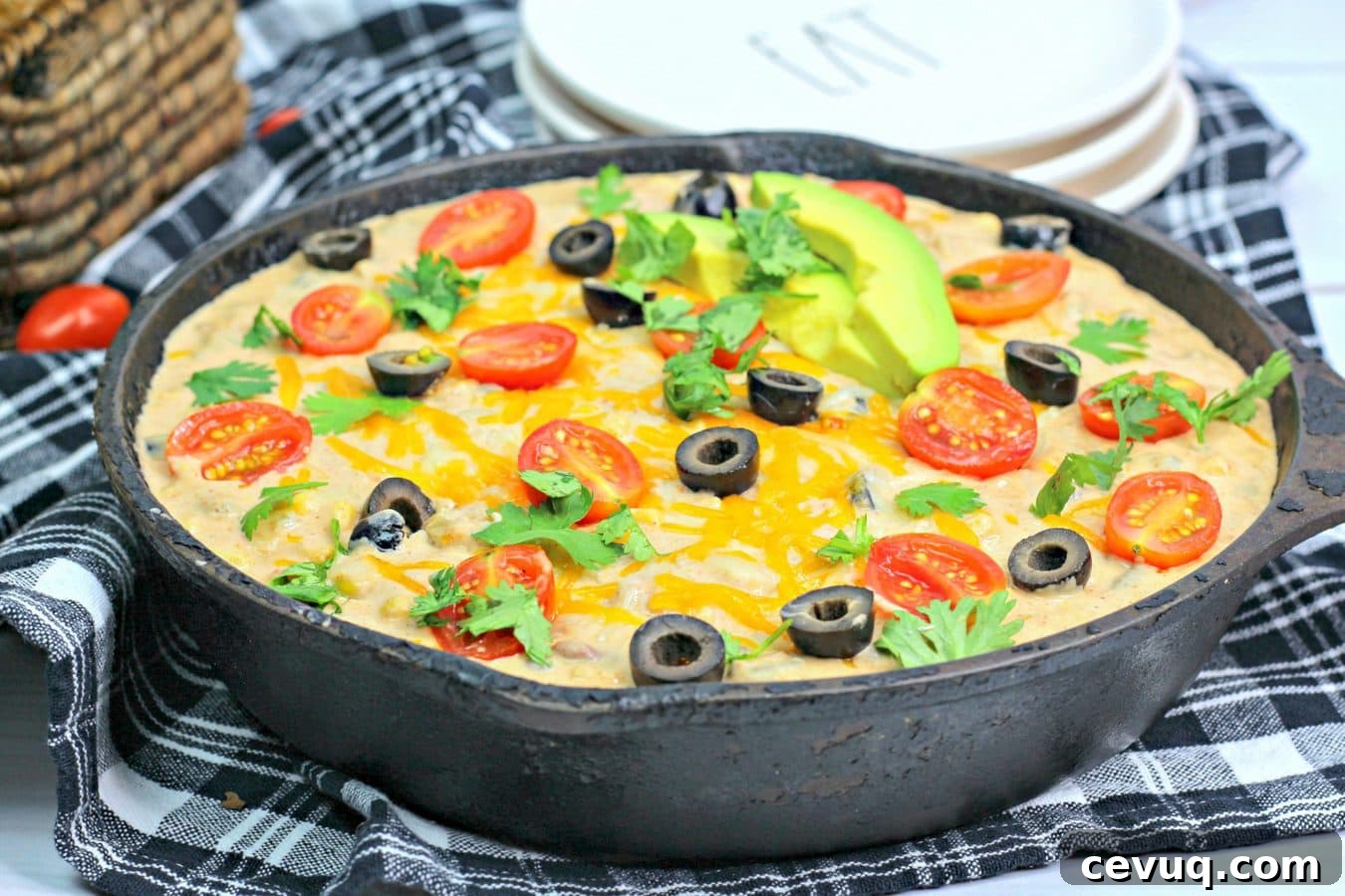 a close up shot on warm bean dip in a cast iron skillet.