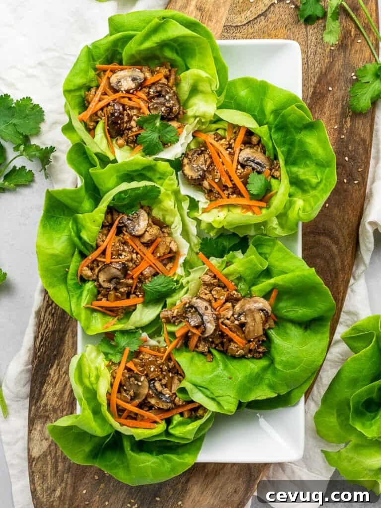 PF Chang's vegetarian lettuce wraps with tofu, mushrooms, carrots, and lettuce on a wooden board