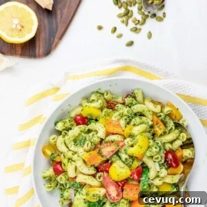 Chilled Vegan Pesto Pasta Salad Recipe for Summer Meals 14 cold vegan pesto pasta salad with tomatoes and vegetables in a white bowl with lemon