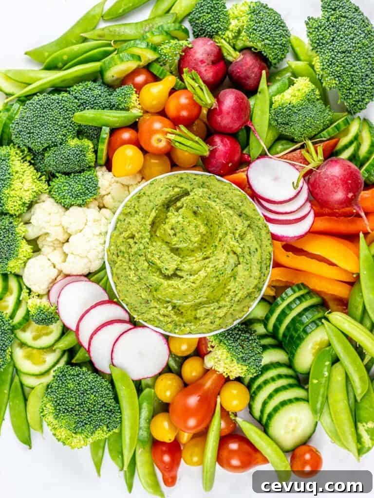 cilantro jalapeno hemp seed hummus surrounded by a vegetable platter
