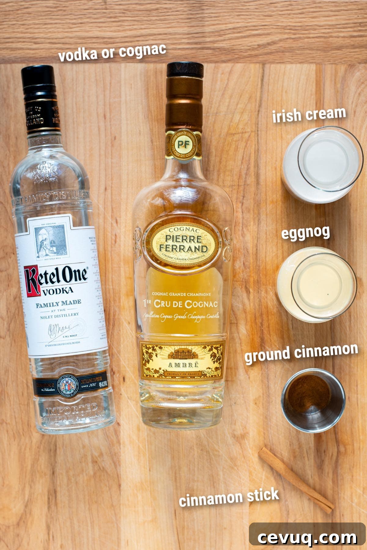Eggnog cocktail ingredients laid out on a wooden cutting board.