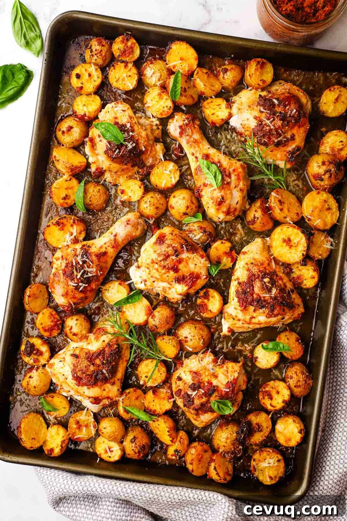 a baking sheet with sun dried tomato pesto chicken