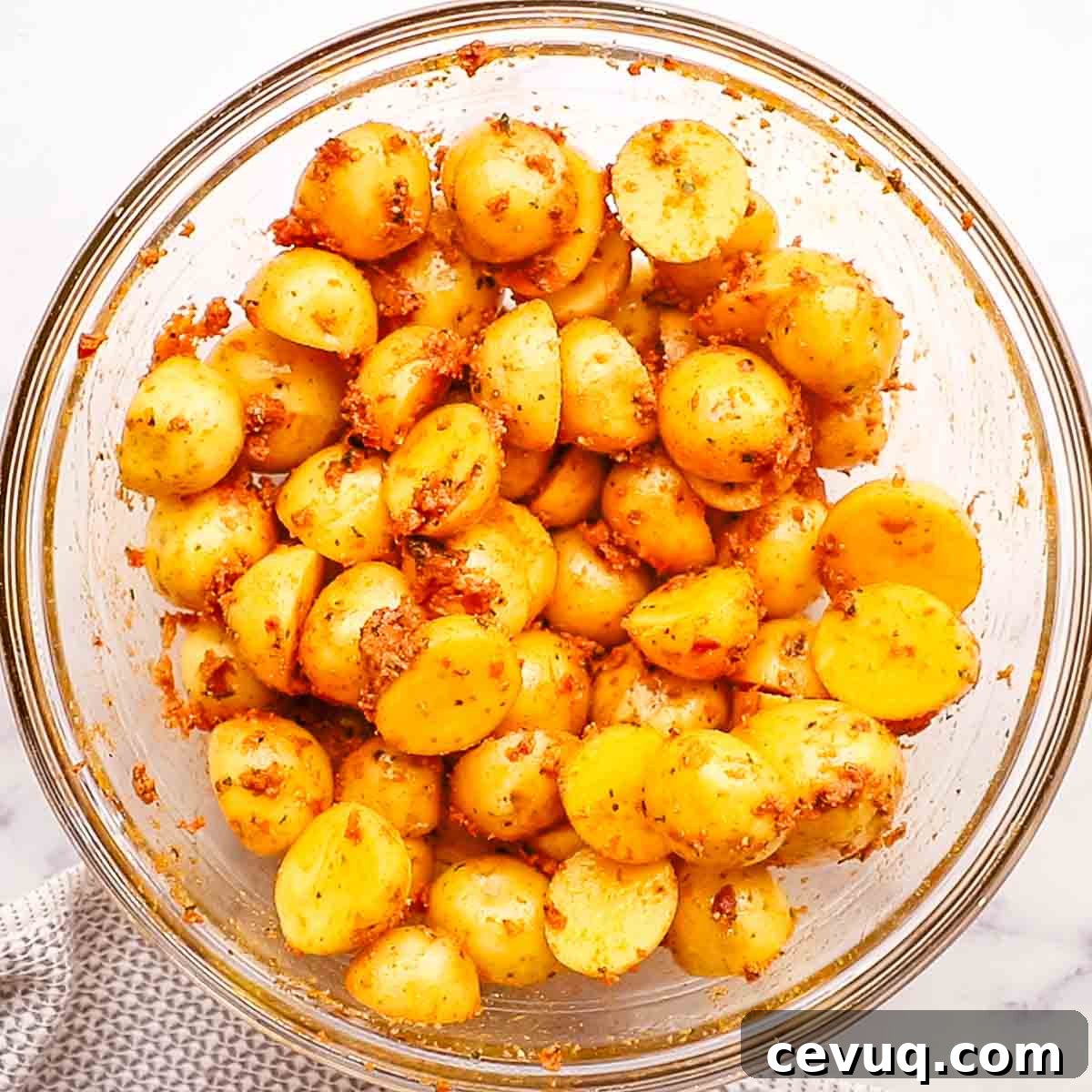 baby potatoes coated with sun dried tomato pesto in a bowl