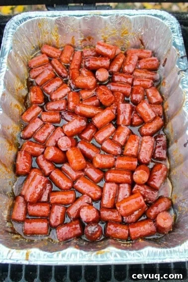 The smoked hot dog burnt ends ready to be pulled from the smoker.