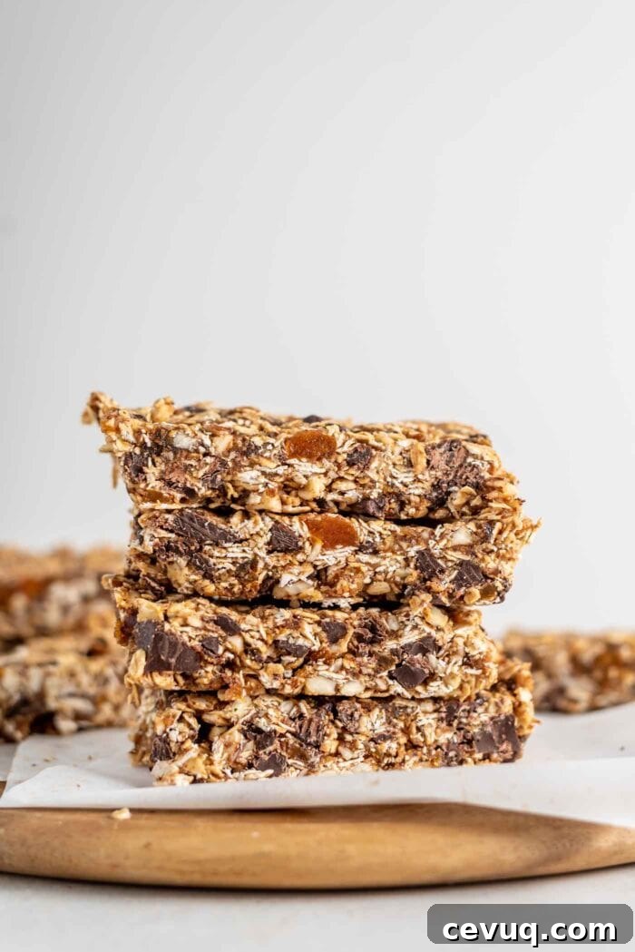 A stack of homemade granola bars on a cutting board.