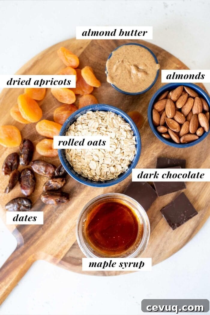 Labelled ingredients for making granola bars, in containers on a cutting board.