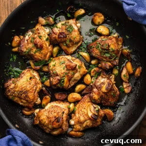 Garlic-Infused Roasted Chicken with 40 Cloves 7 40 clove garlic chicken in large black pan.