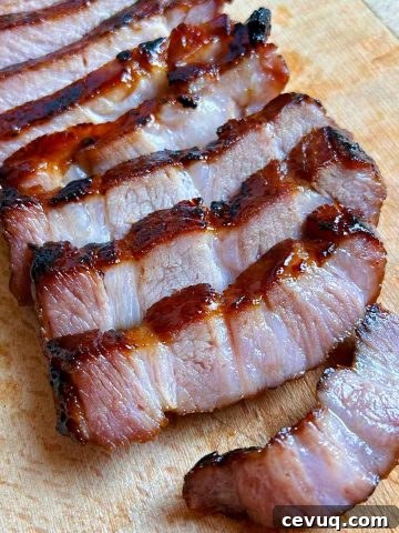sliced char siu on cutting board