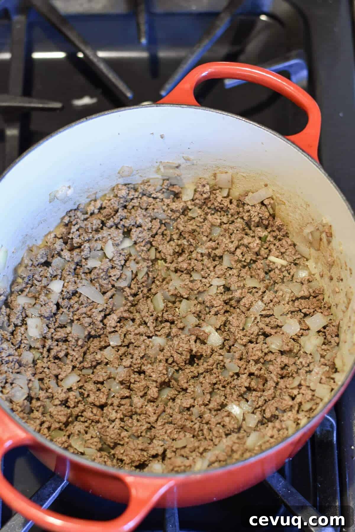 Ground beef and onions browning in a Dutch oven for chili.