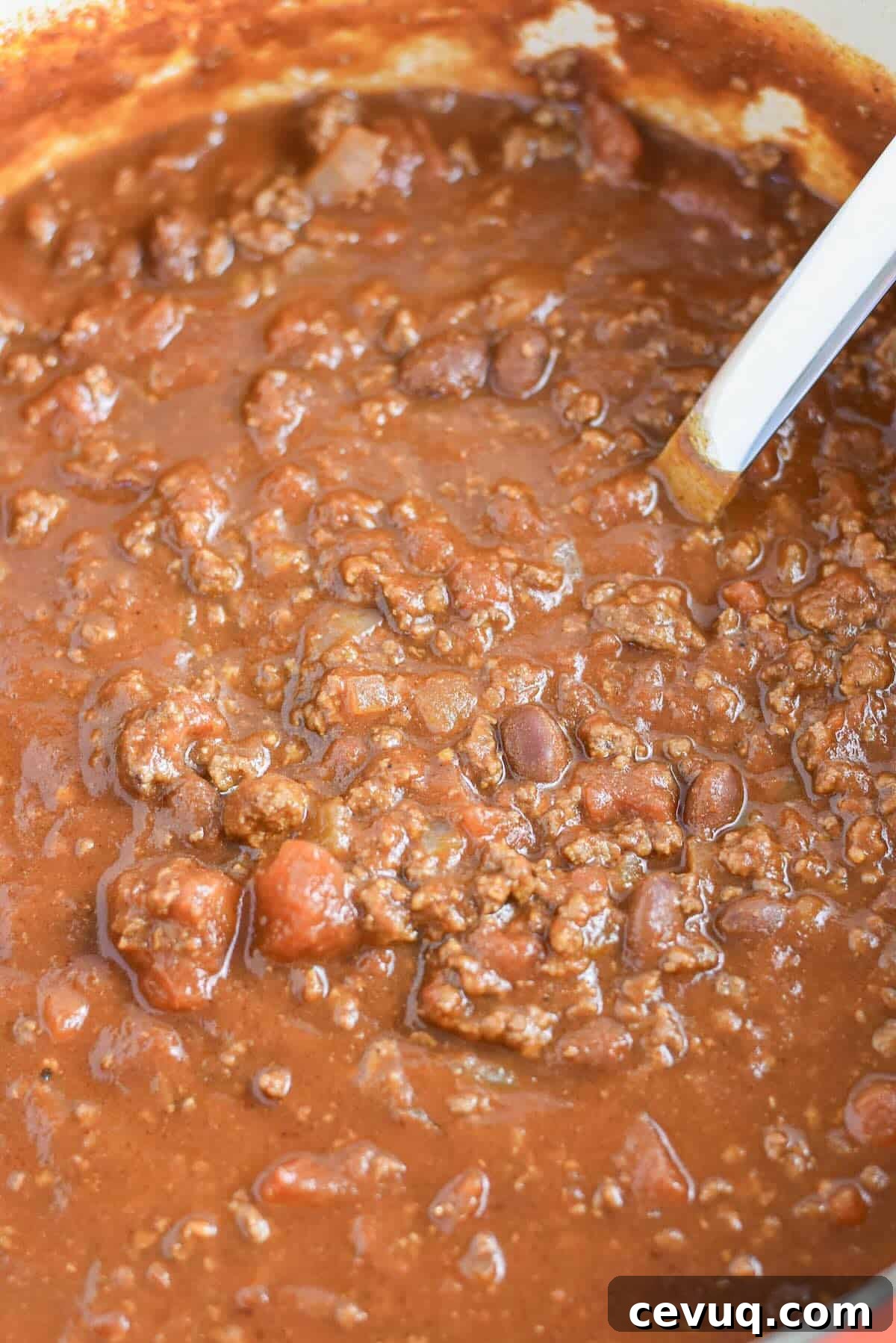 Classic chili for a crowd simmering in a Dutch oven.