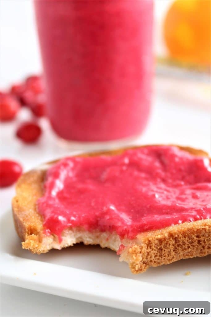bite taken out of toast with cranberry curd