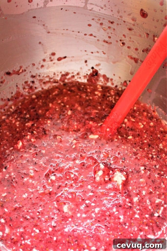curdled looking cranberry curd in mixing bowl