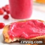 bite taken out of toast with cranberry curd
