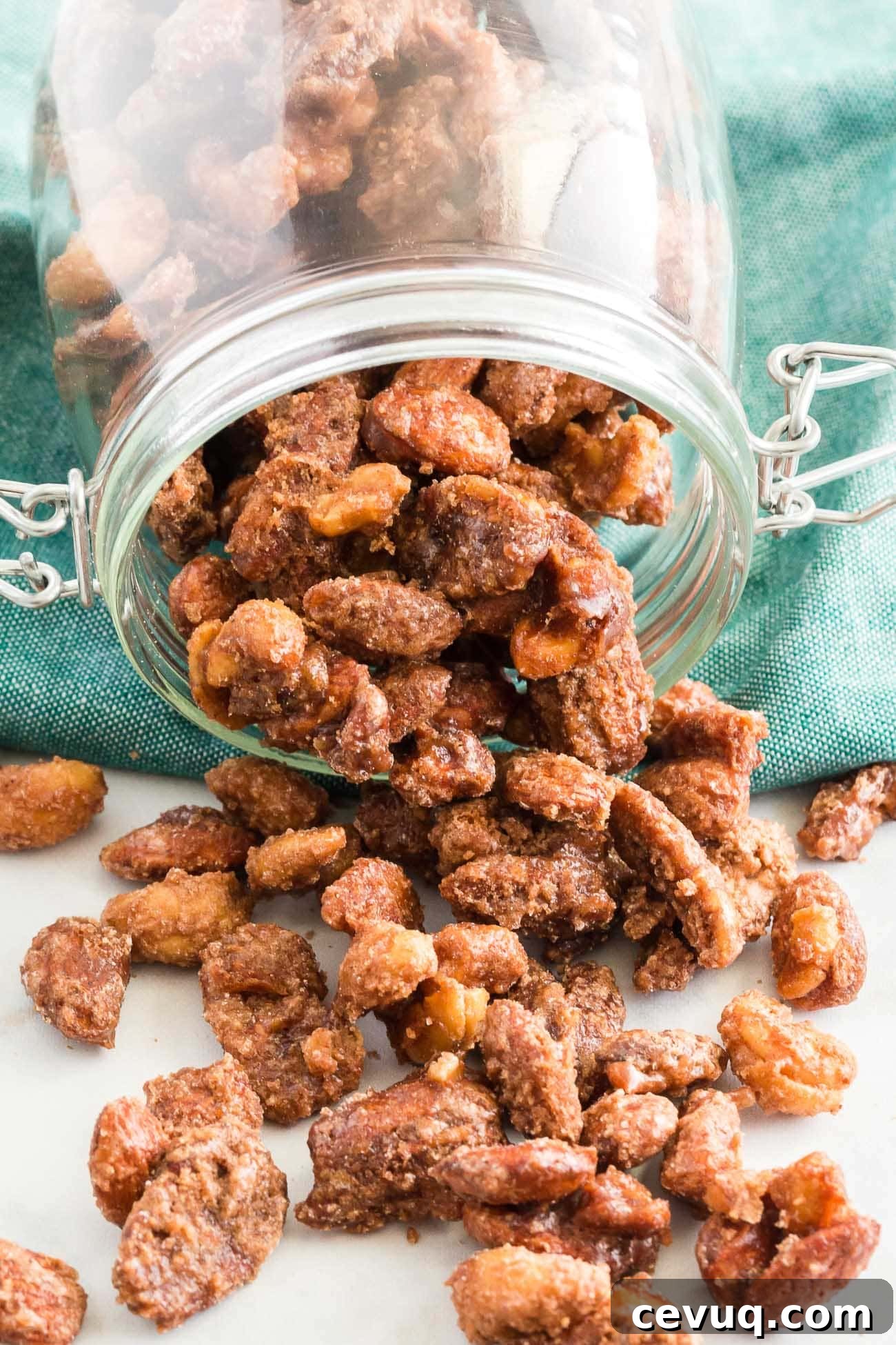 candied nuts being portioned into mason jars for hostess gifts