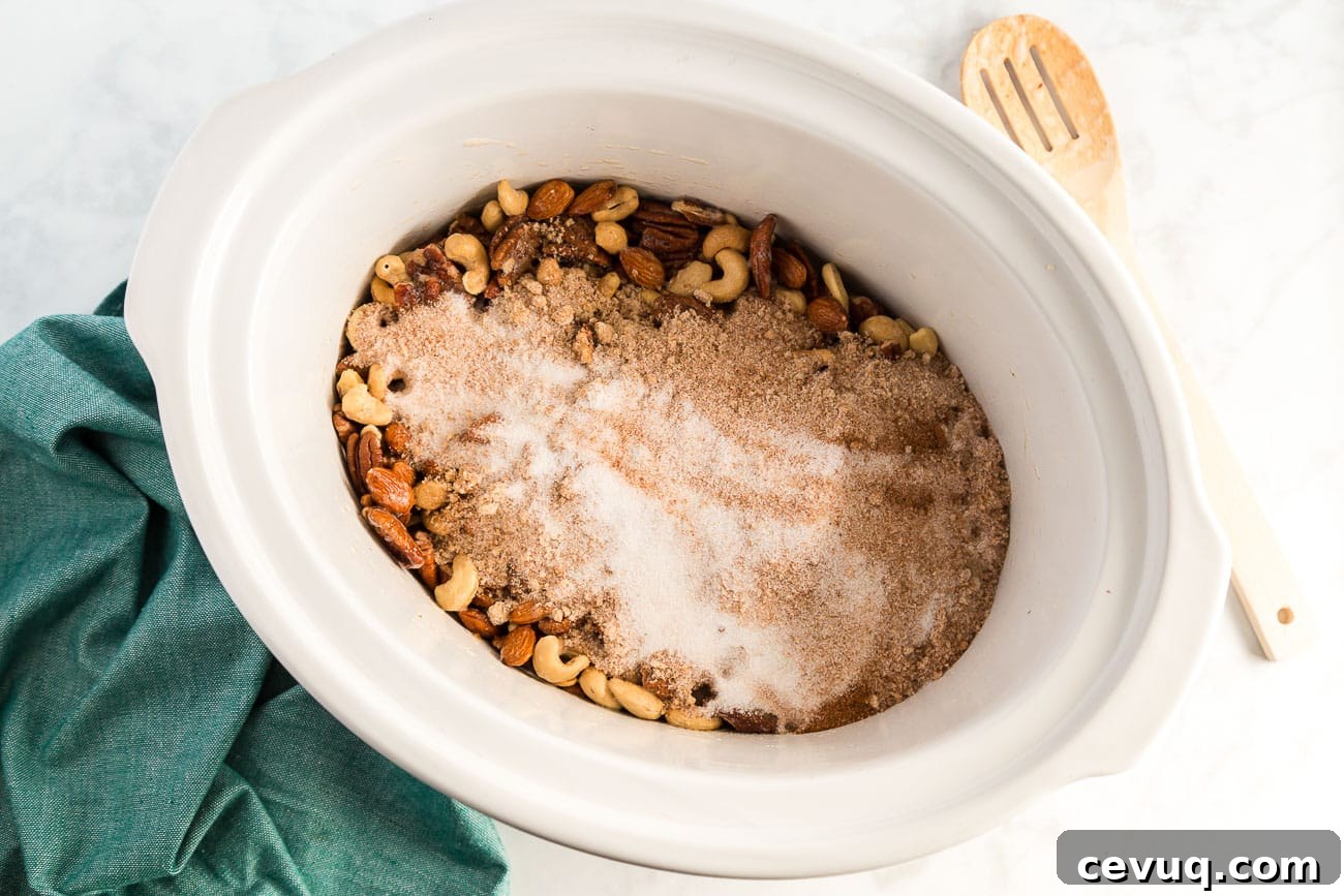 sprinkling brown sugar and white sugar mixture over mixed nuts