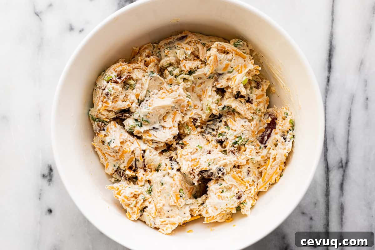 White bowl filled with jalapeno popper filling.