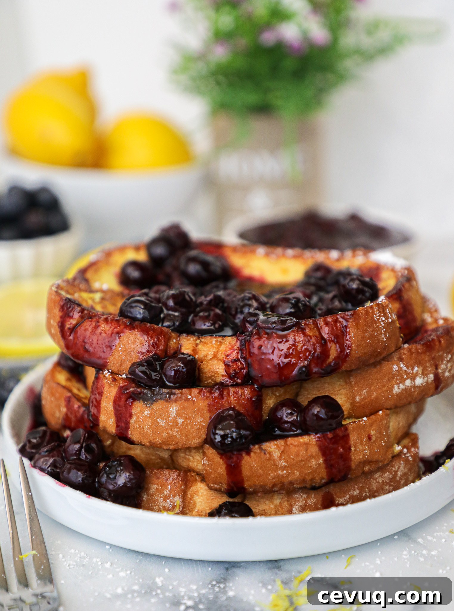An incredibly delicious french toast recipe that's bursting with fresh lemon flavor! It's paired with a sweet blueberry compote for a breakfast meal that just screams summer!