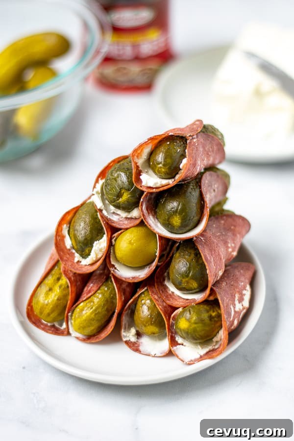 tall stack of dried beef pickle roll ups on a white plate