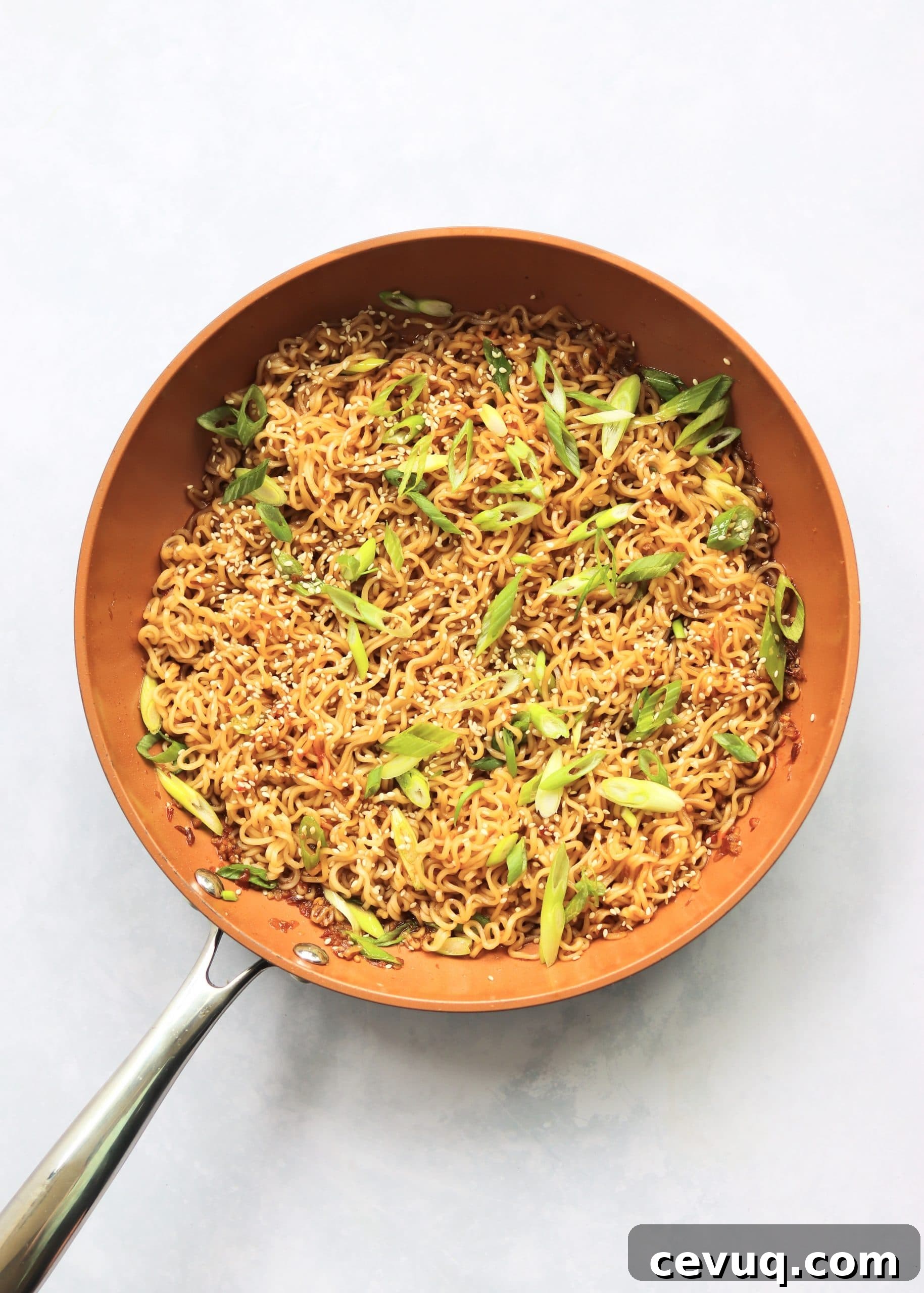 Garlic Sesame Ramen for Two: Quick Homemade Recipe 5 Ramen noodles tossed with sauce and green onions in skillet