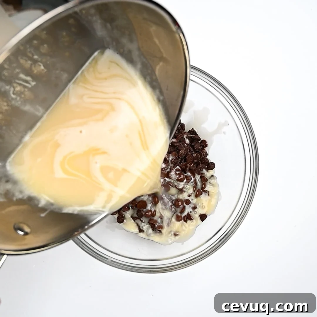 Warmed liquid ingredients being poured over chocolate chips.
