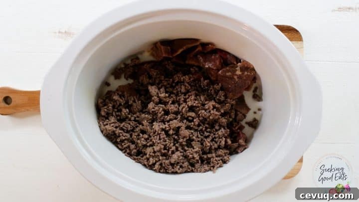 Adding cooked ground beef to the slow cooker