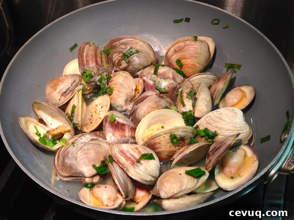 Sake-Steamed Clams Recipe from Yumivore: Simple Japanese Flavor 4 Using a wok style pan, making sake steamed clams.