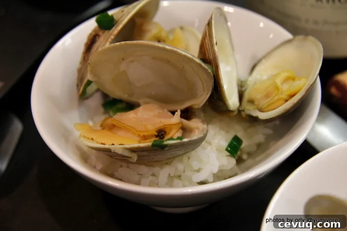 Sake-Steamed Clams Recipe from Yumivore: Simple Japanese Flavor 5 A serving of sake steamed clams in a rice bowl on Japanese rice.